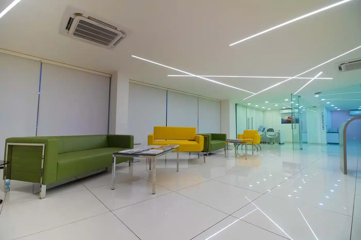 Sanghi Medical Centre bright green and yellow patient lounge, Kerala, Rzianz Infrastructures