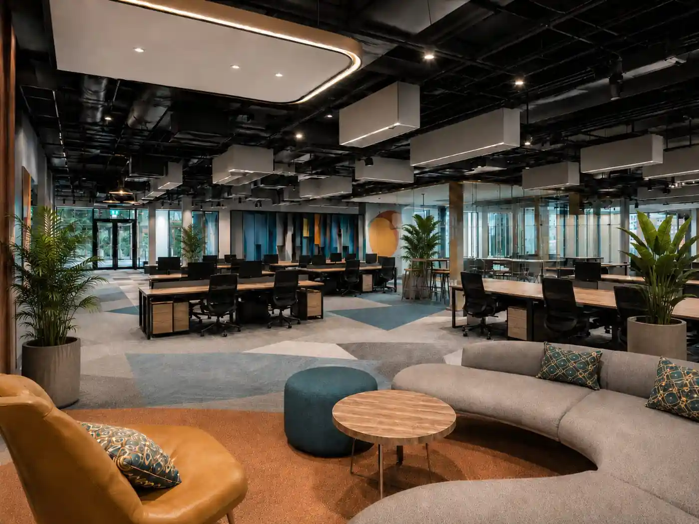 Office workspace with breakout lounge seating, Trivandrum, designed and built by Rzianz Infrastructures